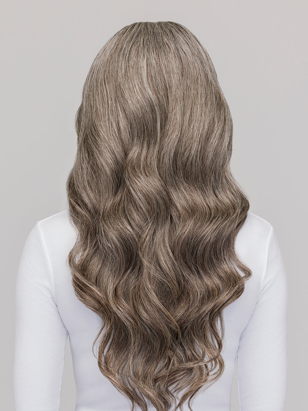 Back view of Indique Pure Gray Wavy wefted extensions, showcasing natural wave pattern and sheen.